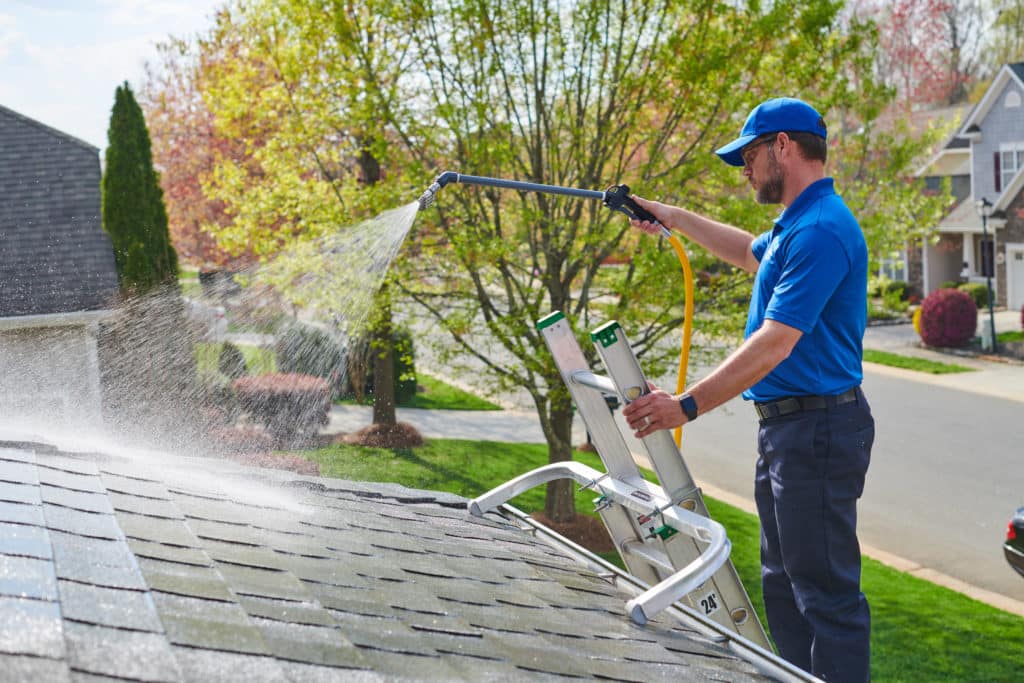 Mansfield Services soft washing a shingle roof in Vermont