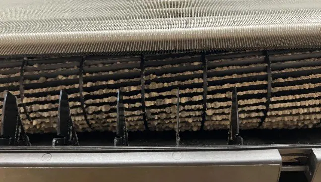 Mold and grime buildup inside a dirty mini split head before cleaning by Mansfield Services in Vermont